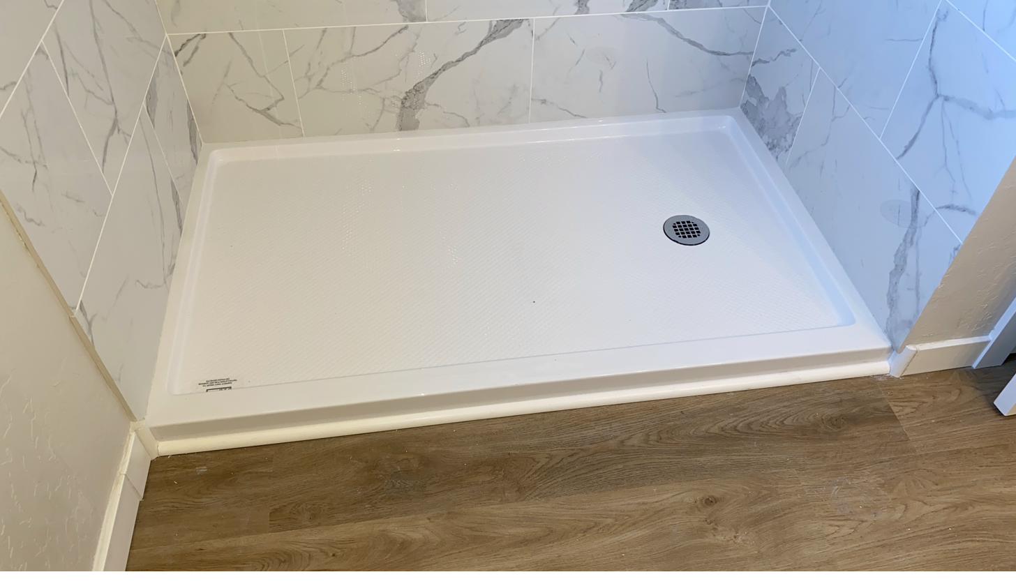 Shower base with marble tile